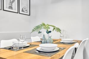 a dining room table with white chairs and a plant at Apartmány BD Boží Dar by Mountain ways in Boží Dar +15 photos
