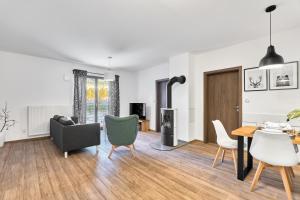 a living room with a table and chairs at Apartmány BD Boží Dar by Mountain ways in Boží Dar