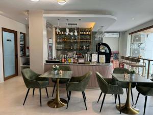 a restaurant with two tables and chairs and a bar at Olive's Suites in Kalibo