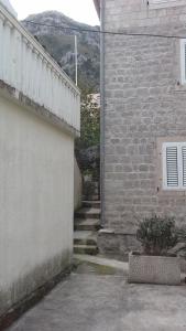 a brick wall with stairs next to a building at Apartment Radovic in Kotor