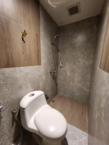 a bathroom with a toilet and a shower at HOTEL PANTES SIMPANG LIMA SEMARANG in Semarang +45 photos