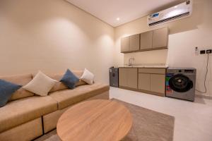 a living room with a couch and a table at Rewaq Resident رواق ريزدنت in Medina