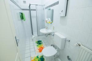 a bathroom with a shower and a toilet and a sink at City Residences Koblenz in Koblenz +55 photos