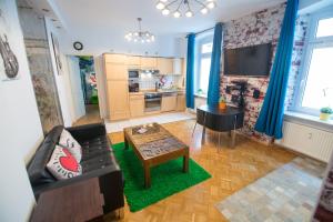 a living room with a couch and a table at City Residences Koblenz in Koblenz