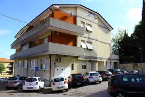 a building with cars parked in front of it at La casa del Darda 3 in Ancona