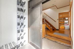 a pivot door in a home with a wall of knives at Kalik House in Nozawa Onsen