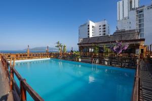 a large swimming pool in a city with buildings at Happy Light Central Nha Trang in Nha Trang