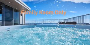 a bath tub filled with water with the words family room only at Seaside Condominium Rana Chatan in Chatan