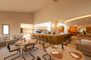 a restaurant with tables and chairs and a bar at Golden Tulip Avignon Le Paradou in Avignon +102 photos