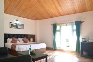 a bedroom with a bed and a large window at Burpeepal in Gangtok