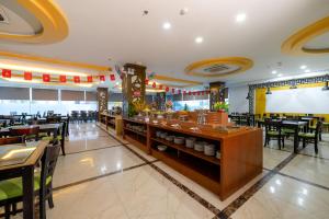 a restaurant with a bar and tables and chairs at Happy Light Central Nha Trang in Nha Trang