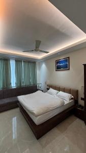 a bedroom with a large bed with a ceiling at Hotel Buransh in Haldwāni