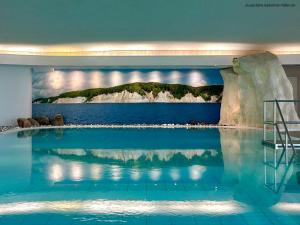 a swimming pool with a view of the ocean at RÜGEN-HOTEL mit Ostseeblick in Sassnitz