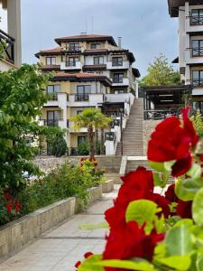 a large building with stairs and flowers in front of it at Апартаменти Литорал in Chernomorets