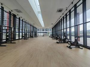 a gym with treadmills and ellipticals in a large building at De' Moysis Homestay in Batu Caves