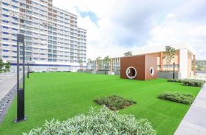 a large lawn in front of a building at De' Moysis Homestay in Batu Caves