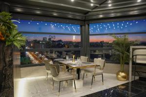 a dining room with a table and chairs in front of a window at New Park Hotel in Ankara