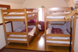 a room with three bunk beds in a room at Sun Terrace Hakone in Hakone