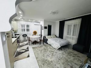a living room with a bed and a table at Leomar Apartament in Gravellona Toce
