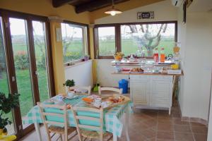 a kitchen with a table and chairs with food on it at Alla Bigattiera in Osimo