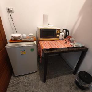 a small table with a microwave and a refrigerator at Krabi Home and Beyond-Ao Nang in Ao Nang Beach