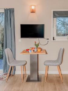 a living room with a table and two chairs at Sea You Soon in Callantsoog