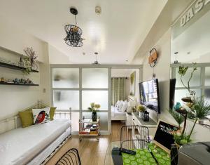 a living room with a couch and a tv in it at An Oasis in Tagaytay in Tagaytay +36 photos