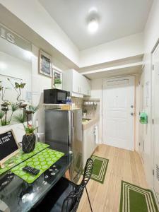 a small kitchen with a table and a refrigerator at An Oasis in Tagaytay in Tagaytay