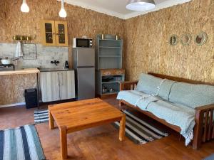 a living room with a couch and a table at Olivias Cottage in Knysna