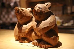 a wooden sculpture of two dogs sitting on a table at SappoLodge in Sapporo