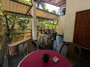 a patio with a table and chairs and a door at Erene Inn in Ella