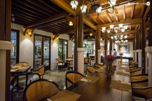 a dining room with a long table and chairs at Buri Sriping Riverside Resort & Spa in Chiang Mai