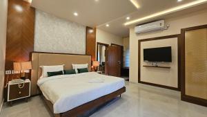 a bedroom with a large bed and a television at Stellar 23 Resort in Whitefield