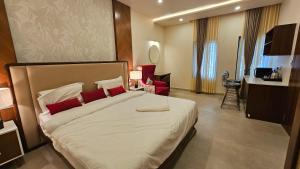 a bedroom with a large bed with red pillows at Stellar 23 Resort in Whitefield