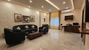 a living room with a couch and a table at Stellar 23 Resort in Whitefield