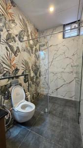 a bathroom with a toilet and a shower at Stellar 23 Resort in Whitefield