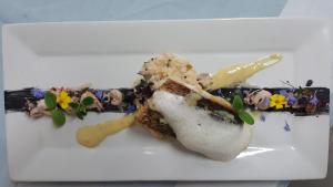 a dessert on a white plate on a table at LOGIS - Hôtel & Restaurant Le Gonfalon in Germigny-lʼEvêque
