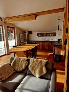 a living room with a couch and a wooden table at Faschingalm Loft in Lienz