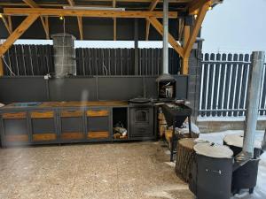 an outdoor kitchen with a stove in a backyard at Chalet 1391 in Ryskulovo +9 photos