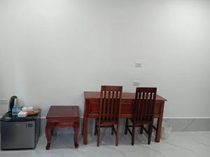 a wooden table with two chairs and a table with a table at Villa ThreeD Xaydara in Luang Prabang +18 photos