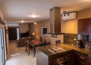 a kitchen and living room with a table and a couch at Casa Rosales in Los Mochis