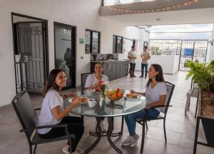 three women sitting at a table eating food at Casa Rosales in Los Mochis +2 photos