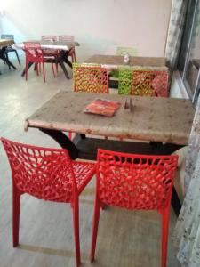 a table and chairs in a room with tables and chairs at Mount aura stay & Dine in Kanatal