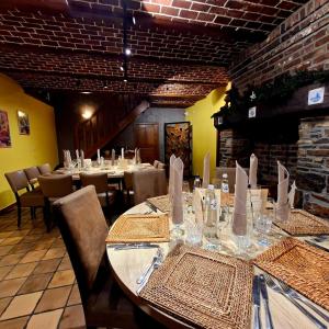 a dining room with a long table and chairs at Hotel-Restaurant La Crémaillère in Jalhay