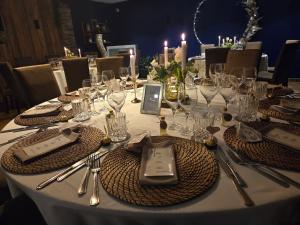 a table with glasses and silverware on top of it at Hotel-Restaurant La Crémaillère in Jalhay +4 photos