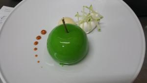a green apple sitting on top of a white plate at LOGIS - Hôtel & Restaurant Le Gonfalon in Germigny-lʼEvêque +46 photos