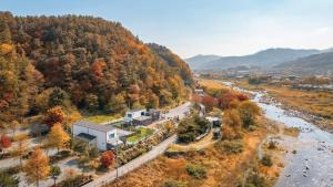 an aerial view of a house and a river at Gapyeong Dangdangi Pet Poolvilla Blue in Gapyeong +11 photos