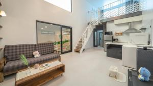 a living room with a couch and a table at Gapyeong Dangdangi Pet Poolvilla Blue in Gapyeong