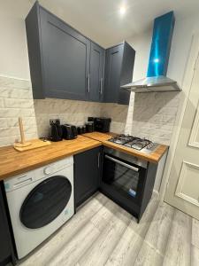 a kitchen with a stove and a microwave at Whitford living 2 in Jarrow +2 photos