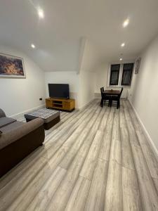 a living room with a couch and a table at Whitford living 2 in Jarrow